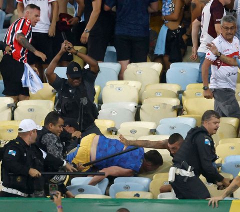 Bentrokan terjadi menjelang laga Brasil vs Argentina dalam Kualifikasi Piala Dunia 2026 Zona Amerika Selatan di Stadion Maracana, Brasil, Rabu (22/11/2023) pagi WIB. Aparat kepolisian terlihat memukuli suporter tim tamu dalam kericuhan tersebut.