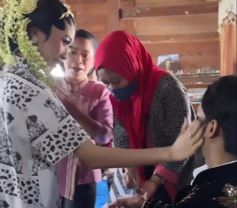 The Action of a Bride who is a MUA, Doing Makeup for Her Own Husband
