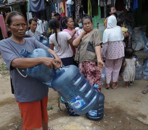 FOTO: Antusiasme Warga Pinggiran Kali Ciliwung Serbu Bantuan Air Bersih