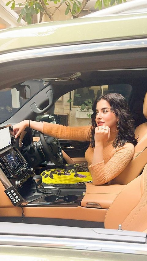 Portrait of Tasya Farasya Showing Off Two Newly Purchased Luxury Cars