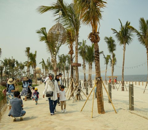 Wisatawan mengunjungi pantai pasir putih dan destinasi kuliner Aloha PIK di kawasan Pantai Indah Kapuk (PIK) 2, Tangerang, Banten, Senin (25/12/2023). Aloha PIK merupakan sebuah destinasi tematik baru yang berlokasi di pantai pasir putih sepanjang empat kilometer.