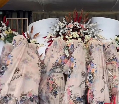 The Ladies' Group at a Wedding Wearing Matching Floral Outfits, Ended Up Looking Like Wedding Decorations in Photos with the Bride and Groom