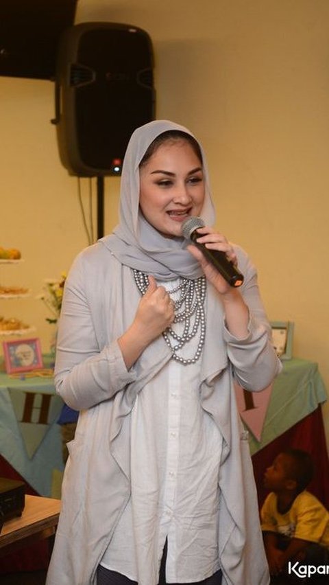 Biasa tampil dengan rambut terurai, penampilan presenter ini terlihat menawan dengan hijab pashmina.