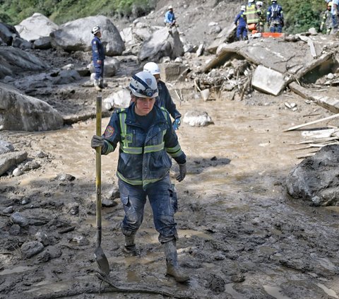Anggota tim penyelamat membawa skop saat bekerja di lokasi musibah tanah longsor yang menghantam kotamadya Quetame, departemen Cundinamarca, Kolombia.