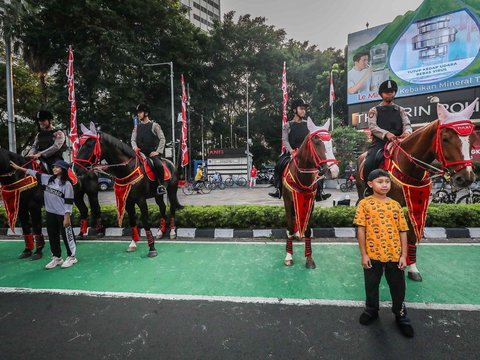 FOTO: Momen Polisi Berkuda Sapa Pengunjung CFD Jakarta, Jadi Ajang Selfie