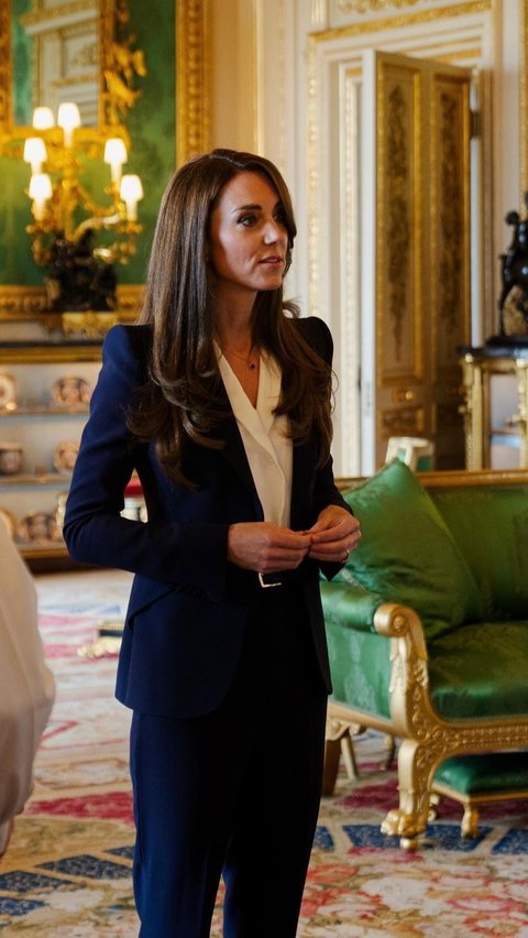 Blue suit klasik juga jadi andalan formal look Kate Middleton. Ia memadukan blazer klasik dan straight pants, dengan inner blus putih.