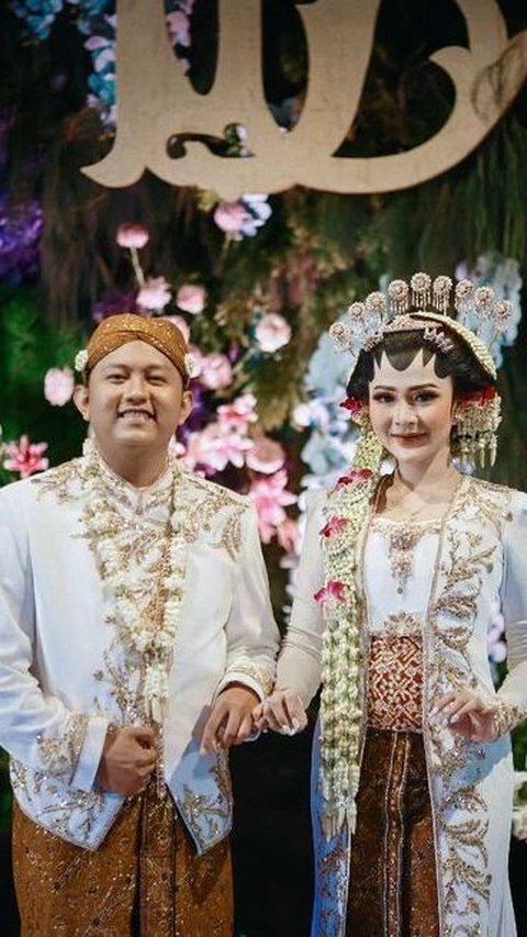 Denny Caknan dan Bella Bonita tampil menawan dengan mengenakan busana adat Jawa berwarna putih. Senyum kebahagiaan terlihat terpancar wajah mereka.