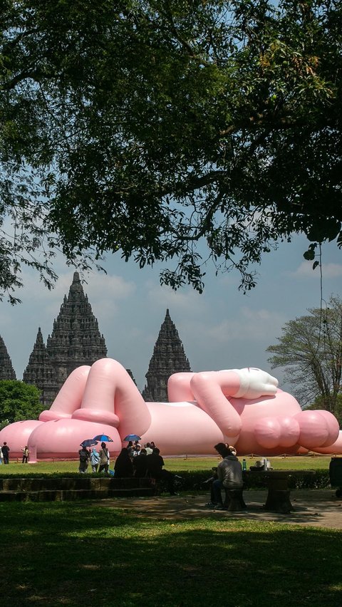 FOTO: Momen KAWS Liburan di Indonesia, Begini Potretnya Saat Asyik Rebahan di Candi Prambanan