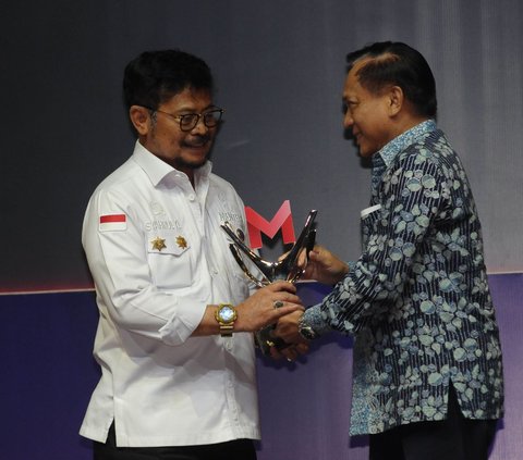 Direktur SCM Imam Sudjarwo (kanan) memberikan penghargaan kategori Program Inovatif untuk Negeri kepada Menteri Pertanian Syahrul Yasin Limpo pada acara Merdeka Award 2023 di SCTV Tower, Jakarta, Rabu (30/8/2023).<br>