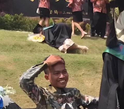 As if One Related Incident, This Graduation Photo Moment Ends in Laughter: Student Behind Falls, Student in Front Laughs Instead