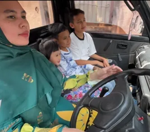 Portrait of Kartika Putri Driving a Pickup Truck, Taking Her Children for a Walk