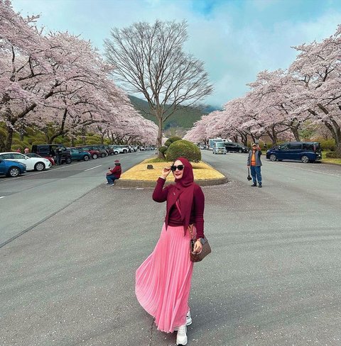 Eddies Adelia poses with a blooming sakura background.