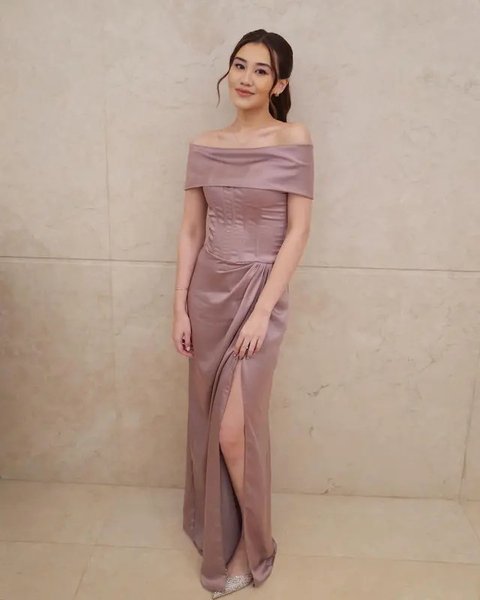 Saat menjadi bridesmaid Mahalini Raharja, Aaliyah Massaid tampil manis dengan off-the-shoulder dress berwarna ungu dan detail high slit.