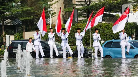 FOTO: Jelang HUT ke-79 Kemerdekaan RI, Aksi Paskibra Kibarkan Merah Putih Hiasi Monumen Selamat Datang