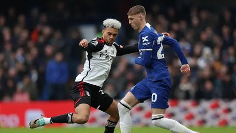 Bek Liverpool, Conor Bradley (depan) menguasai bola dibayangi bek Fulham, Antonee Robinson pada laga leg pertama babak semifinal Carabao Cup 2023/2024 di Anfield Stadium, Liverpool, Kamis (11