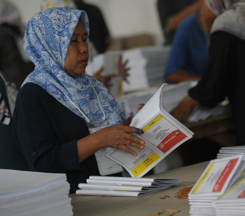Kesibukan pekerja saat melakukan sortir dan pelipatan surat suara DPR RI DKI Jakarta I di sebuah gudang logistik, Jakarta, Selasa (16/1/2024). <br>