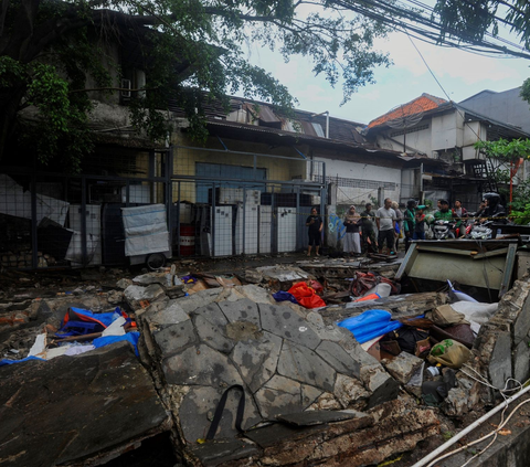 Terlihat kondisi fisik tembok perbatasan SPBU yang roboh tampak berserakan di Jalan Tebet Barat Dalam Dua, Jakarta Selatan, Minggu (21/1/2024) siang.<br>( Foto merdeka.com / Arie Basuki )