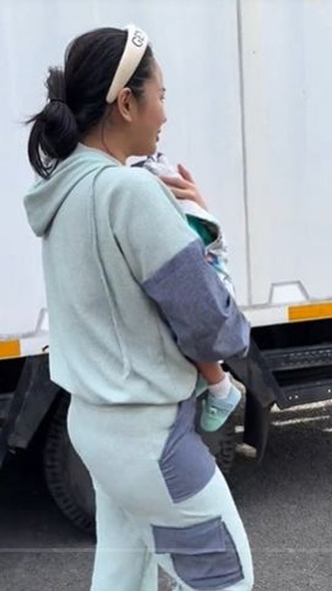 Denise is seen pacing back and forth while carrying Jaden, her son.