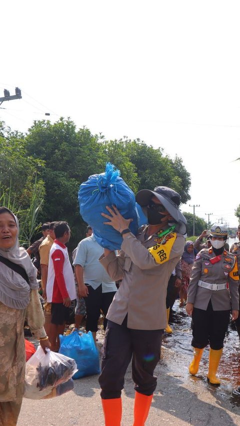 Usai Sosialisasi Pemilu, Kapolres Rohil Angkat Barang Warga Saat Evakuasi Korban Banjir
