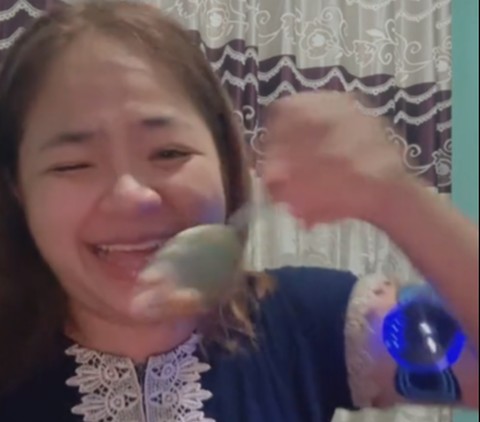 Funny Moment of a Woman Eating Porridge Using an Electric Massage Tool, Ending Up with a Spoon Hitting Her Eye