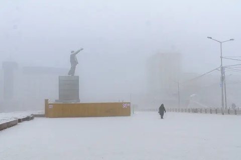 Orang-orang menyekop salju dari jalan layang setelah hujan salju lebat di Yantai, di provinsi Shandong, China timur pada 20 Desember 2023. Suhu di kota-kota di China utara mencapai rekor tere