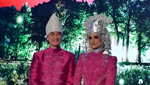 Untuk acara resepsinya, Putri dan Zumi memilih warna pink fuschia. Kebaya modern ini dipadukan dengan mahkota adat Jambi, daerah asal Zumi Zola.