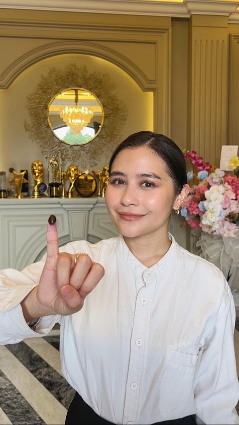 Prilly Latuconsina tampil cantik berbusana putih di hari pencoblosan. Dia menunjukkan jari kelingking bertinta tanda telah memberikan hak suara.