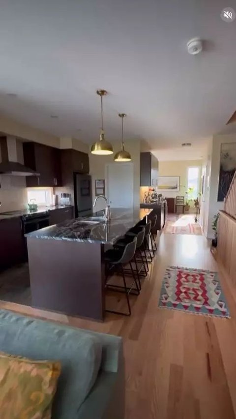 The living room looks spacious, and the kitchen is also aesthetic with a marble table.