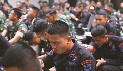 Sementara di hadapan mereka duduk ratusan prajurit TNI dan anggota Brimob yang bersiap akan makan siang bersama.