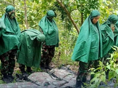 Portrait of Air Force Cadets Praying in the Middle of the Forest During Combat Training, Wearing Camouflage Uniform and Holding Weapons