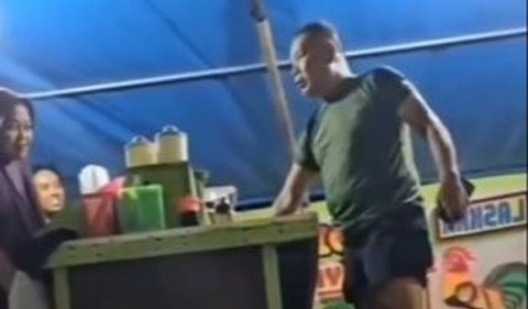 Dalam video berdurasi singkat itu, tampak pria yang mengenakan kaos berwarna hijau tengah marah-marah dan mendatangi meja kasir warung.