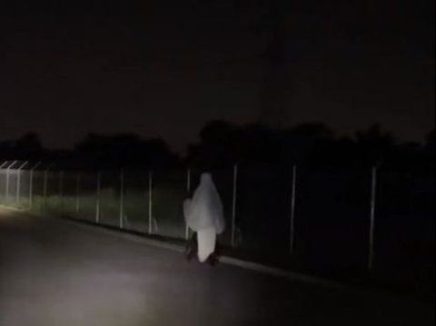 The Moment of a White Figure Floating in the Dark Road, Revealed from Up Close