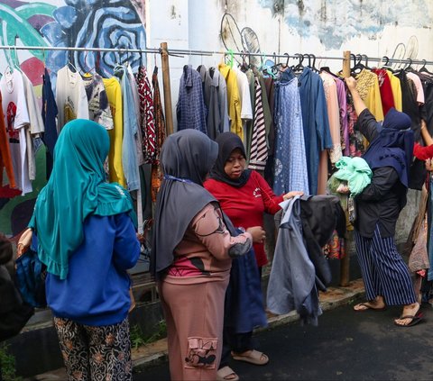 Warga memilih pakaian saat bazar sayuran, bahan makanan dan bahu bekas layak pakai gratis di Jalan Jati Padang VI, Pasar Minggu, Jakarta, Jumat (29/3/2024). Ini menjadi tahun ke-7 bagi warga RT 002/004 Jati Padang dan para donatur menggelar bazar sayuran, bahan makanan, dan baju bekas layak pakai. Merdeka.com/Arie Basuki<br>