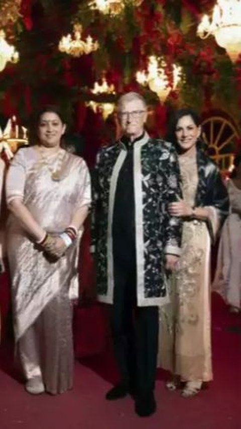 Bill Gates appears to be taking a photo with the invited guests and the family of the prospective bride and groom.