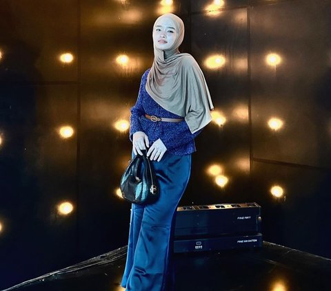 Portrait of Anggun Inara Rusli Wrapped in Dramatic Blue Outfit