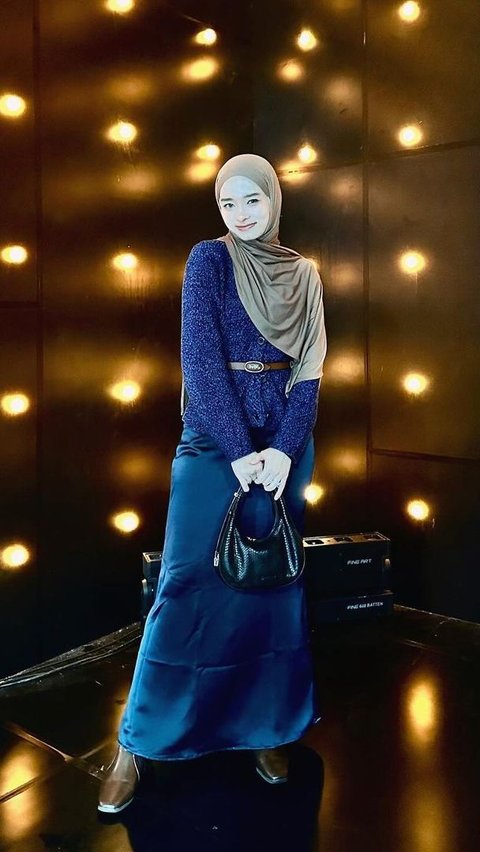 Portrait of Anggun Inara Rusli Wrapped in Dramatic Blue Outfit