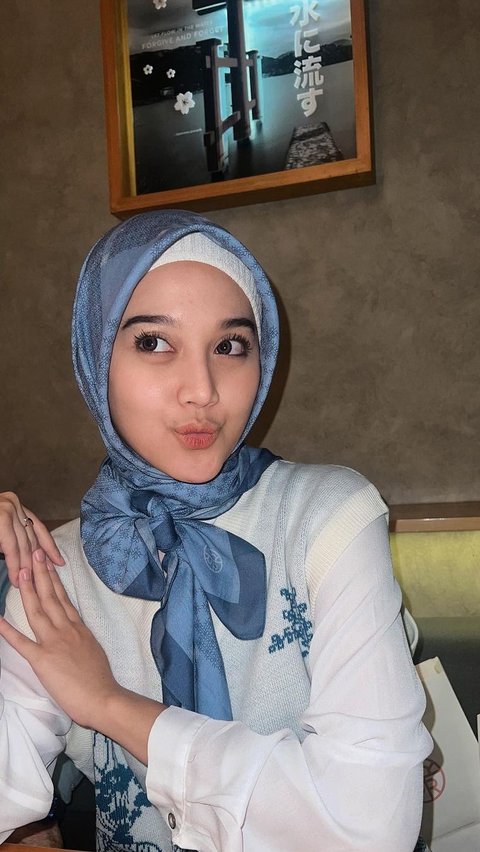 Ini potret Esta Pramanita saat pakai hijab. Ia tampak memakai hijab warna biru muda yang dipadukan dengan baju warna putih.