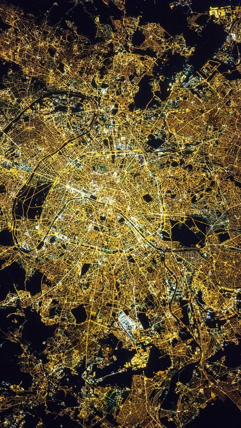 The view of the city of Paris, France at night as seen from outer space.