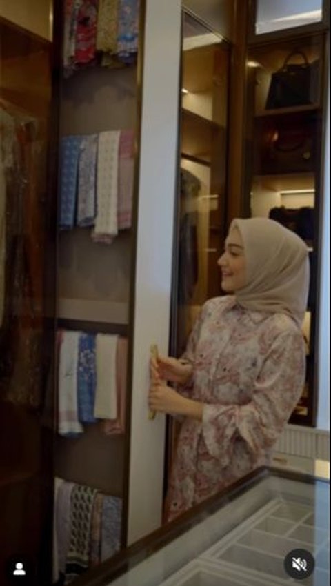 Her hijab is neatly arranged in a unique-shaped wardrobe.