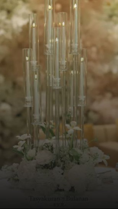 Terdapat juga lilin yang didesain begitu cantik dengan bunga-bunga kecil yang ditaruh di tengah mejanya itu. <br>