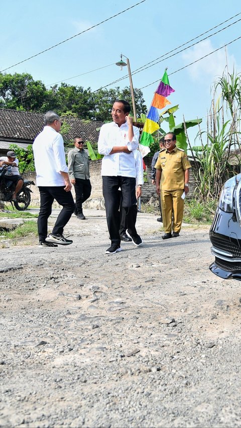 Jokowi kemudian turun dari mobil kepresidenan dan mengecek langsung jalan rusak yang dilewatinya. Foto: BPMI Setpres/Vico