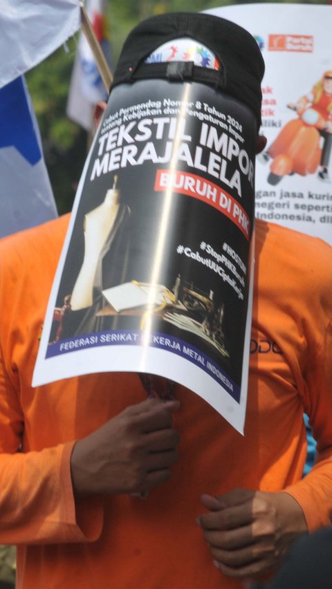 Mereka menunjukkan poster bertuliskan 'Stop PHK Buruh Tekstil'. Foto: merdeka.com / Imam Buhori