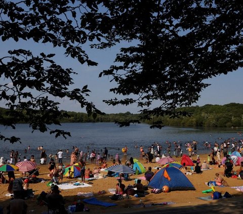 FOTO: Tak Peduli dengan Gelombang Panas, Ribuan Warga Inggris Tetap Asyik Berjemur Padati Tepi Danau dan Pantai