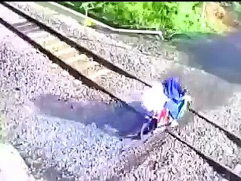 Tense Moments as Rider Nearly Hit by Train, Motorcycle Stuck on Tracks