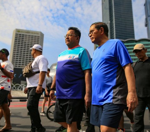 FOTO: Kompak Pakai Kaos dan Celana Pendek, Pasangan Pramono Anung-Rano Karno Olahraga Jalan Santai di CFD Jakarta