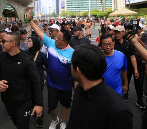 FOTO: Kompak Pakai Kaos dan Celana Pendek, Pasangan Pramono Anung-Rano Karno Olahraga Jalan Santai di CFD Jakarta