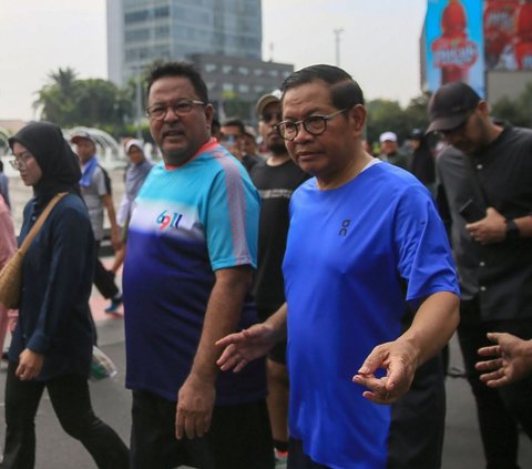 FOTO: Kompak Pakai Kaos dan Celana Pendek, Pasangan Pramono Anung-Rano Karno Olahraga Jalan Santai di CFD Jakarta