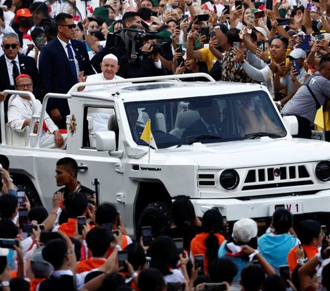 Pemimpin Tertinggi Gereja Katolik Sedunia, Paus Fransiskus melambaikan tangan dari atas kendaraan taktis Maung MV3 buatan PT Pindad saat menyapa para jemaat Misa Suci di Stadion Gelora Bung Karno (GBK), Jakarta, Kamis (5/9/2024). Misa akbar yang dipimpin langsung Paus Fransiskus ini dihadiri lebih dari 80 ribu umat Katolik. Foto: REUTERS/Willy Kurniawan