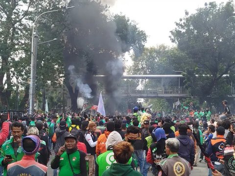 Pengemudi ojek online atau ojol yang tergabung dalam Koalisi Ojol Nasional (KON) berorasi saat melakukan unjuk rasa di Patung Kuda, Jalan Medan Merdeka Barat. (Liputan6.com/Angga Yuniar)