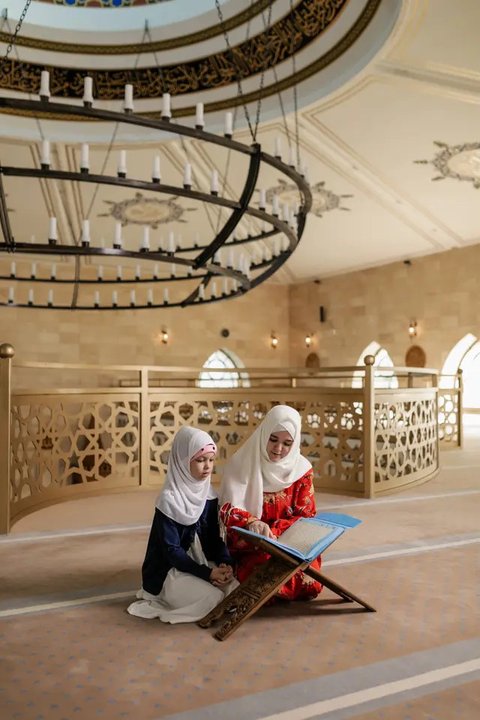 Ilustrasi Islami, muslimah, mengaji, membaca Al-Qur'an. (Foto oleh Alena Darmel/Pexels)